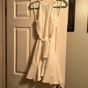 White flowy dress, open back.